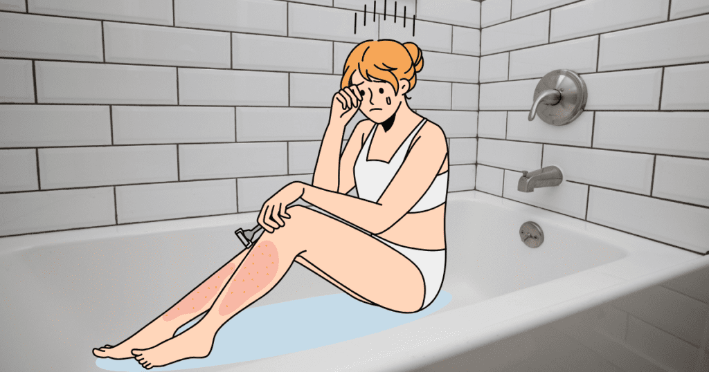 A woman sitting in a bathtub is crying from razor burn pain from shaving her legs.